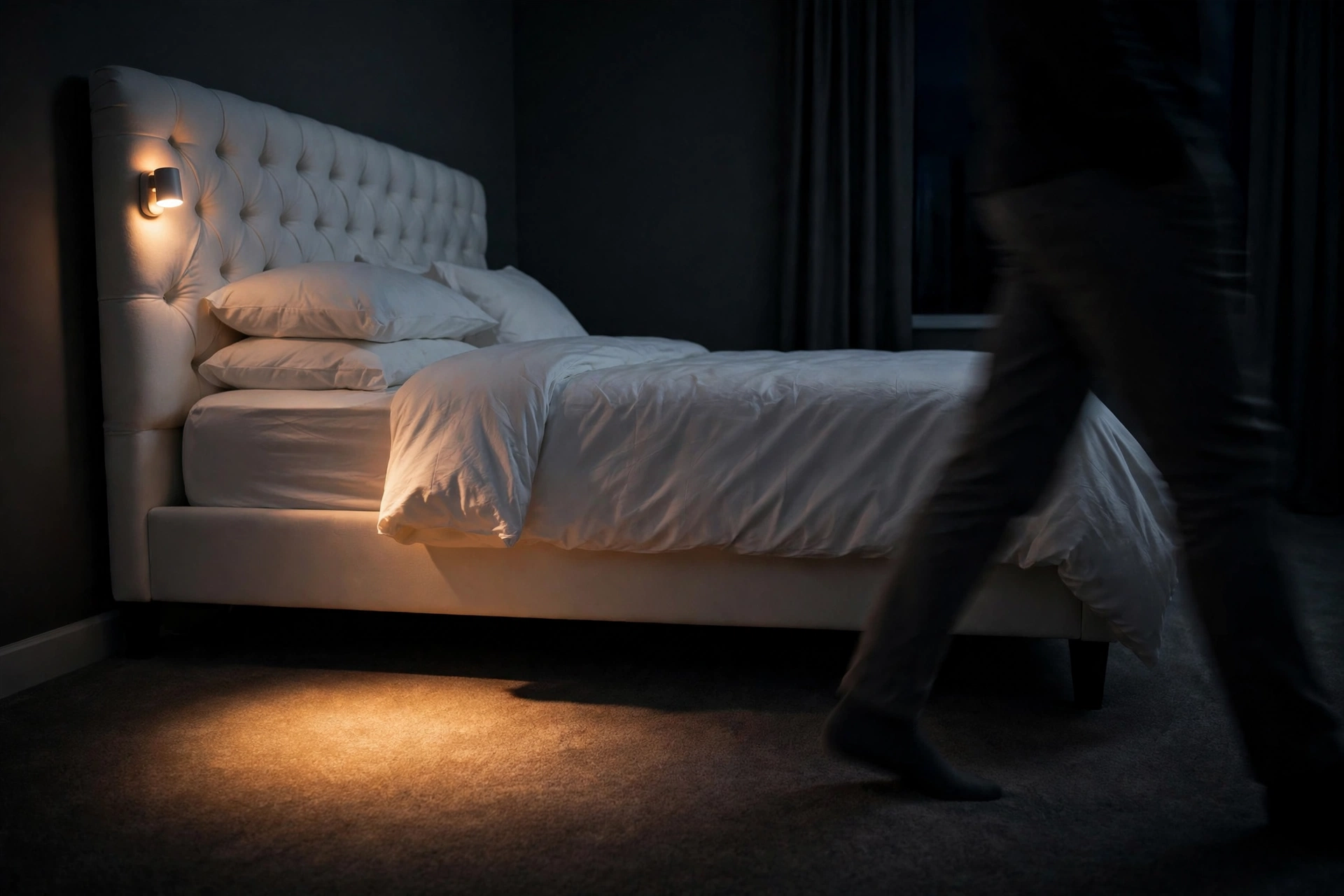 Motion-activated night light glowing on hydraulic storage bed headboard at night