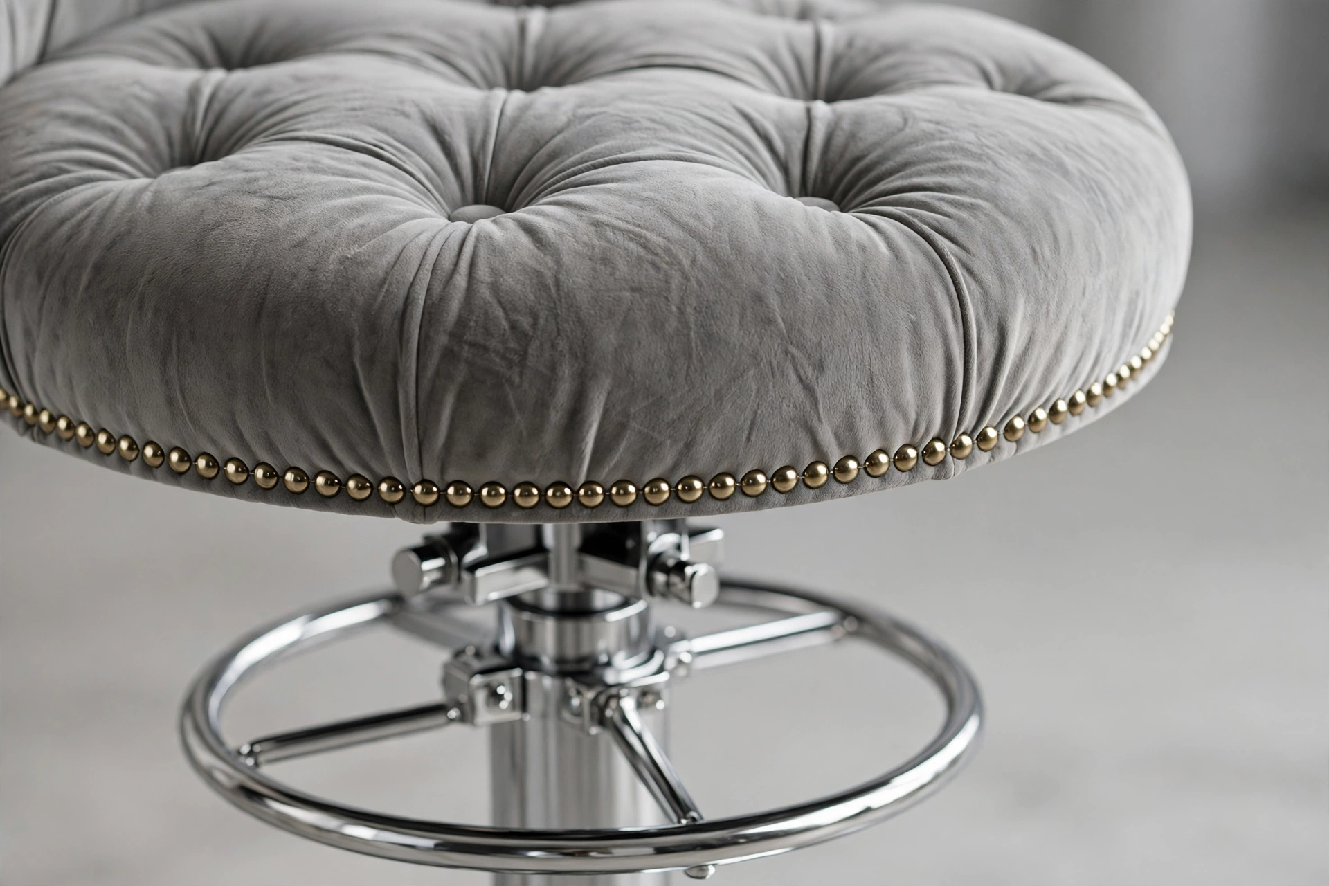 Close-up of button tufting and rivet trim on a velvet swivel bar stool